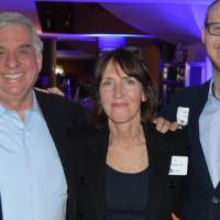 Three alumni pose for a photo together at the Chicago Alumni Reception